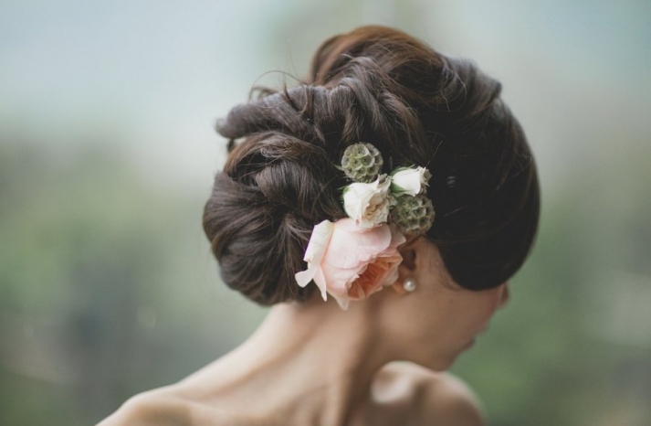 Twisted Textured Updo With Fresh Flowers via OneWed