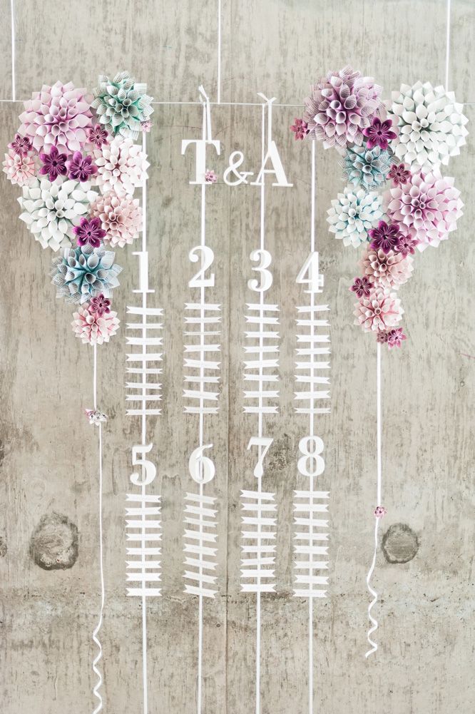 Suspended and hanging seating chart with paper cone flowers by eagle eyed bride Anushé Low Photography